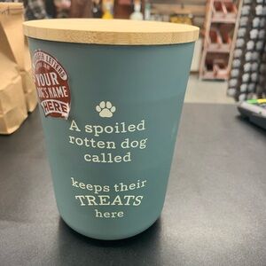 Plastic dog treat jar with wooden cap and customizable letters.